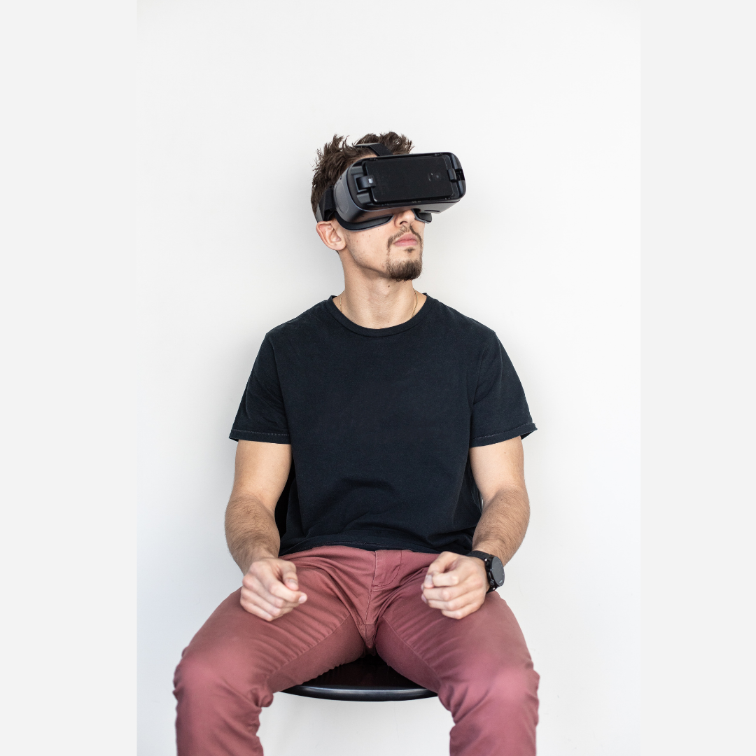 young guy exploring a virtual tour with his VR headset on